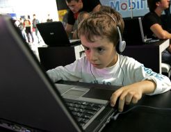 A boy plays on a notebook