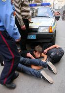 Young people lock the car of militia