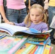 A girl examines a book