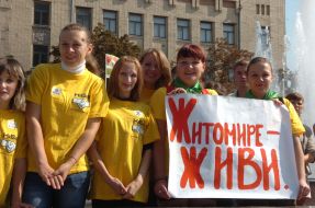 Girls hold a placard