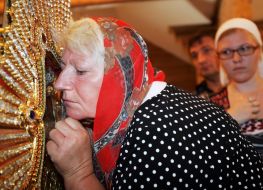 A believer kisses Pochaev Icon of the Mother of God
