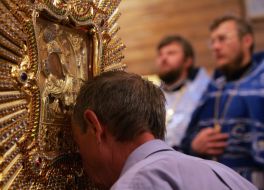 A believer kisses Pochaev Icon of the Mother of God