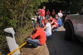 Young people draw out a car from a ditch