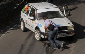 A photographer pushes ”Yalta Rally-2009 Prime” one of саrs