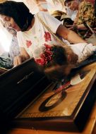 A girl kisses an icon