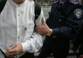 Militia employee holds flash-mob participant