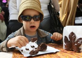 A boy eats sweetnesses