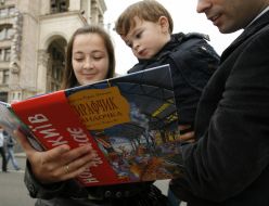 Parents read a book to the child