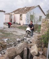 Місцевий жителі прибирають у дворі після урагану