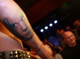 Participant of the festival demonstrates his tattoo