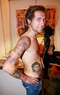 Participant of the festival ”Giper Tattoo-2009” demonstrates his tattoos