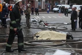 Firemen goes near a body