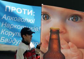 Baby with beer on a placard