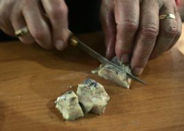 A man cuts a herring
