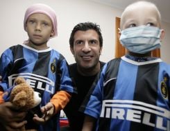 Luis Figo taken pictures with children
