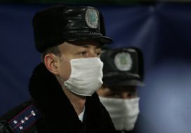 The employees of militia are in respirators masks