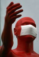 The sculpture of man in a respirator mask