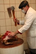 A salesman chops a pork head