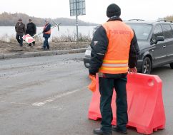 A worker sets a sign-board