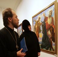 Priests examines a picture