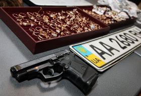 Pistol, gold rings and motor-car registration number