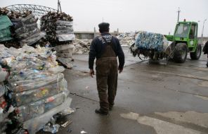 A worker assorts garbage