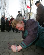 The beaten man lies on earth