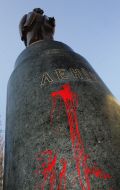 Poured by a red paint monument to Lenin