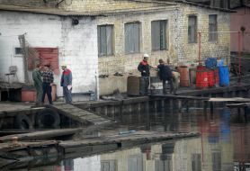 Workers draws fuel oil from Kalmius river