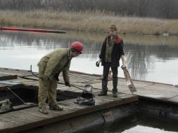 Workers draws fuel oil from Kalmius river