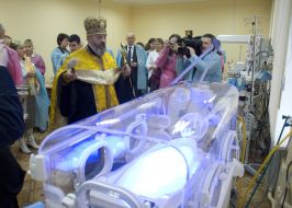 Priest sanctifies an incubator