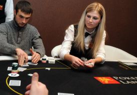 A croupier distributes cards to the players