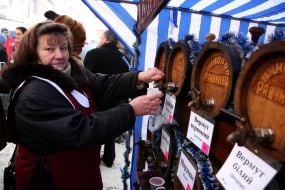 A salesman pours wine from wood