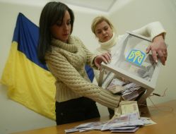 Girls pour out money from a ballot-box