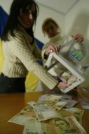Girls pour out money from a ballot-box