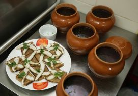 Pots with borsch and sandwiches with fat