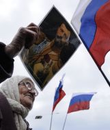 Elderly woman holds the portrait of Nikolay ІІ