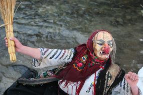 Participant of celebration in the suit of Baba-Yaga