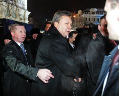 A guard accompanies Victor Yanukovych
