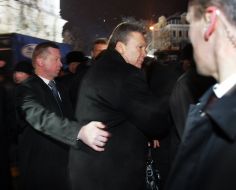 A guard accompanies Victor Yanukovych