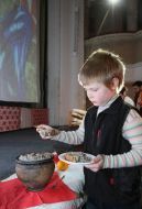 A boy pours itself kutya