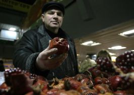 A man selling pomegranates