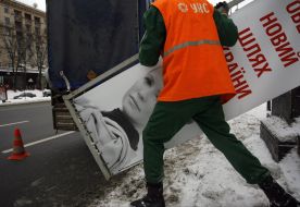 Workers remove campaign billboards