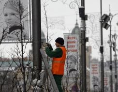 Workers remove campaign billboards