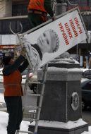Workers remove campaign billboards