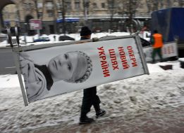 Worker dismantle propaganda billboard