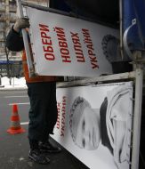 Worker dismantle propaganda billboard