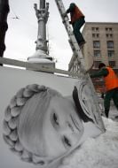 Workers remove campaign billboards