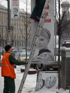 Workers remove campaign billboards
