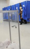 A woman goes out from a polling-booth